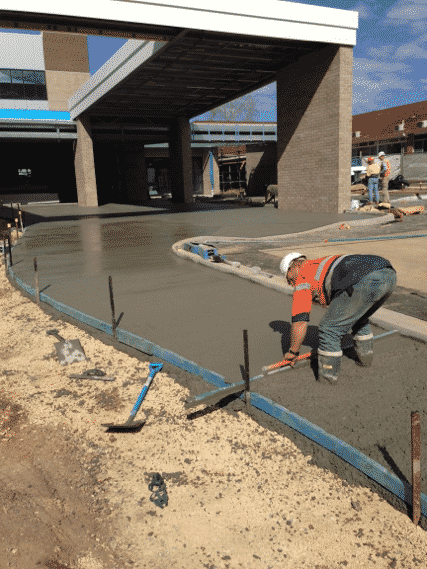 Worker Flattening Concrete ​​— Concreters in Coffs Harbour, NSW